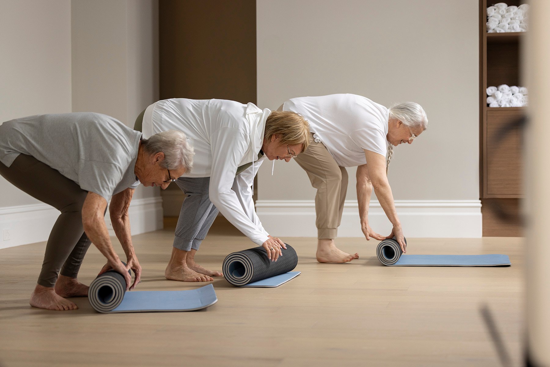 StFrancis women rolling out yoga mats