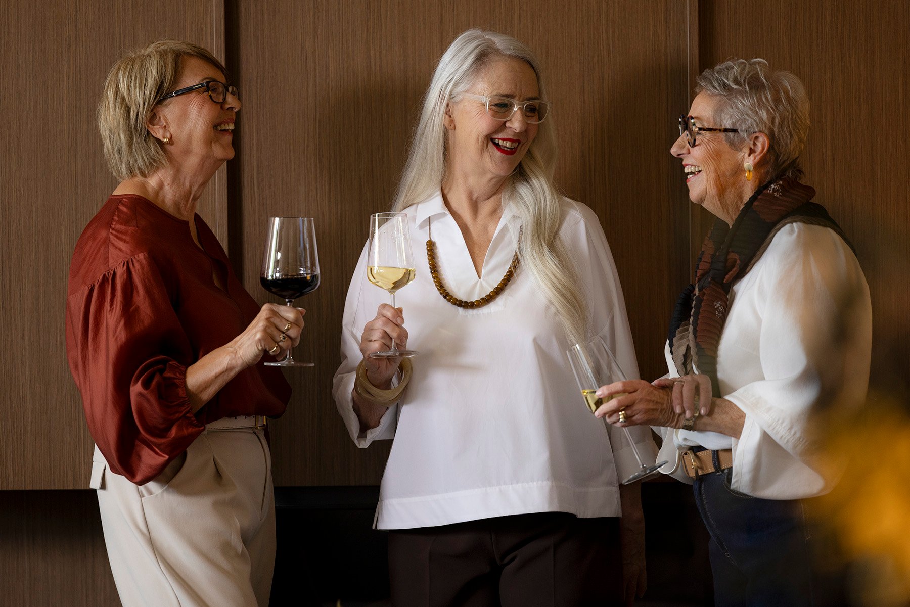 Women laughing and drinking wine at St. Francis